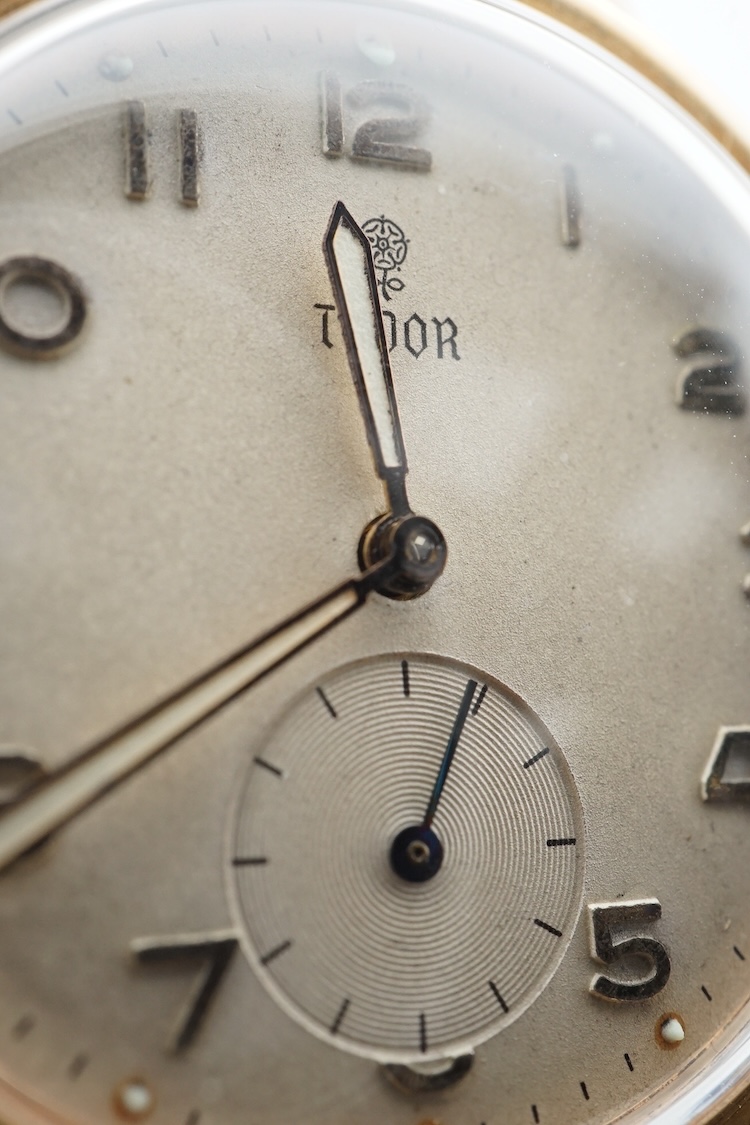 A gentleman's 9ct gold Tudor manual wind wrist watch, with Arabic numerals and subsidiary seconds, case diameter 32mm, on an associated leather strap, with a Garrards box.